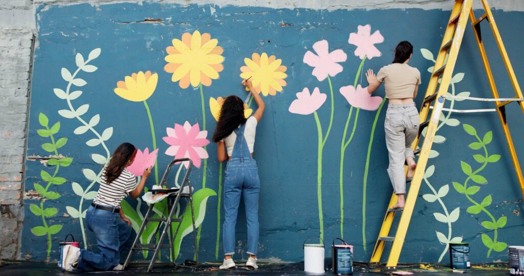 Community members painting a mural.
